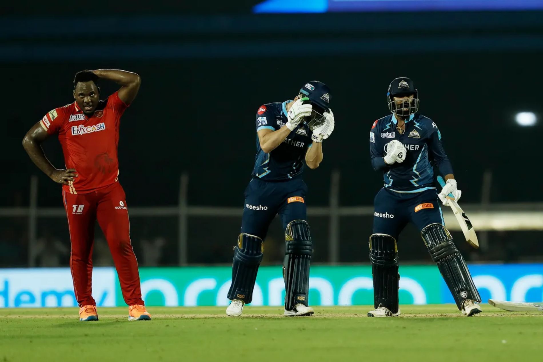 Odean Smith (left) and Rahul Tewatia (right) react after the latter clubs the former for two sixes off the last two balls in Match 16 between PBKS and GT.
