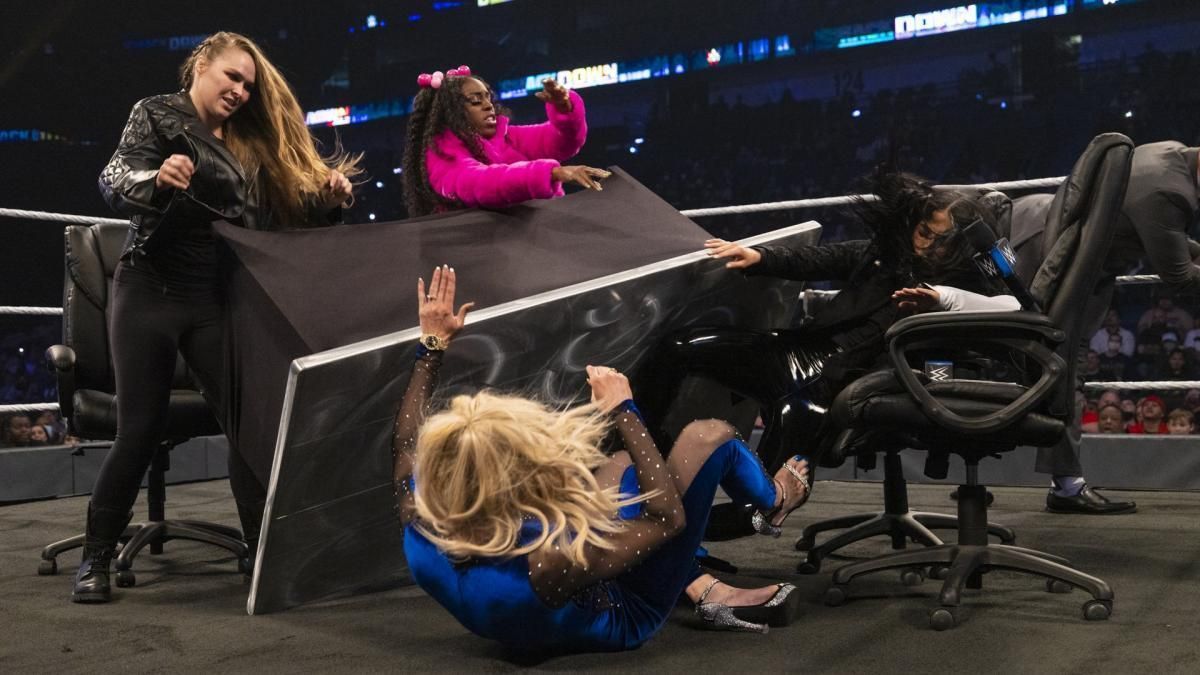 Ronda Rousey turning the table over onto Charlotte Flair on SmackDown