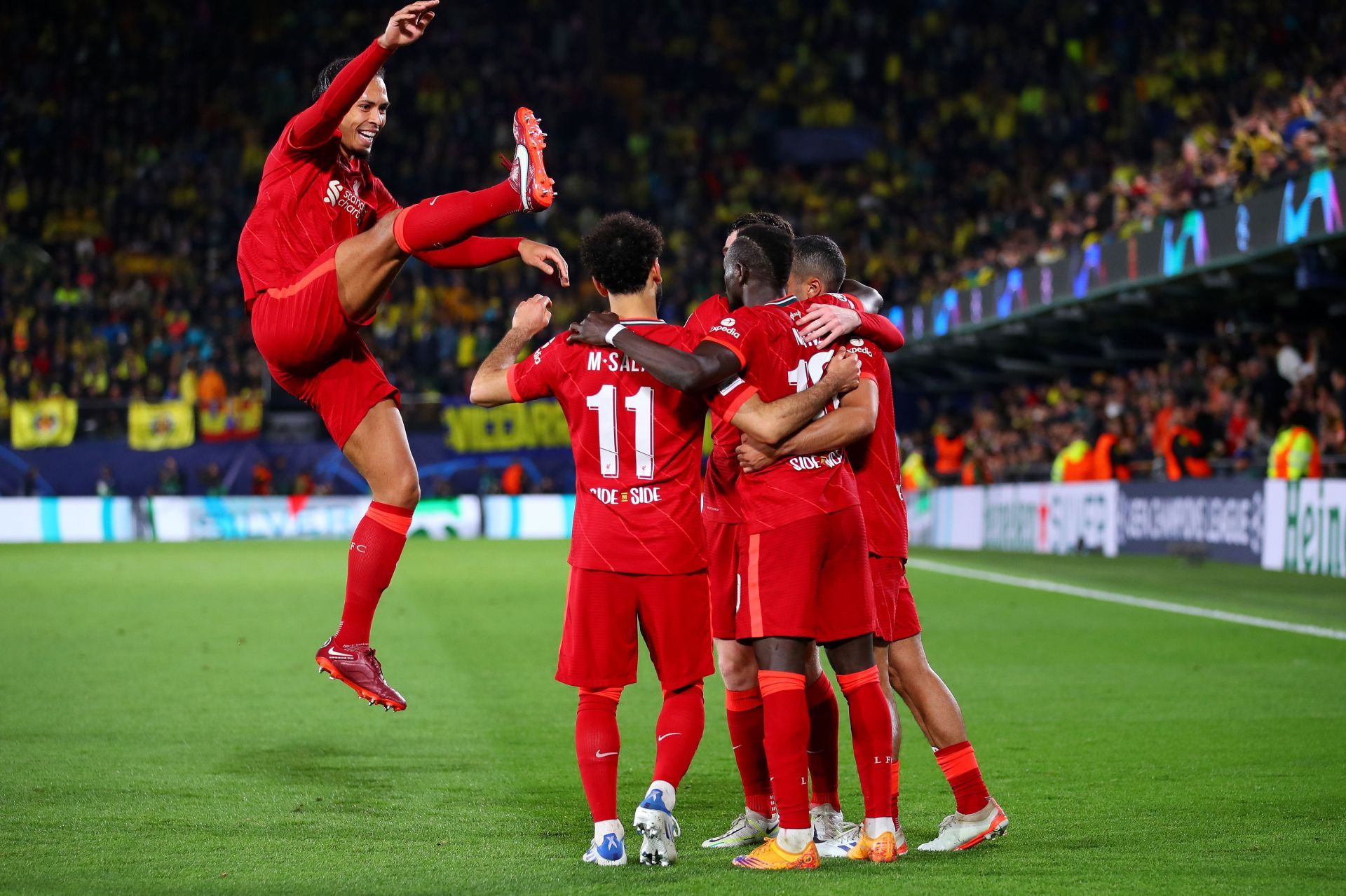 Liverpool players celebrate after scoring a goal.