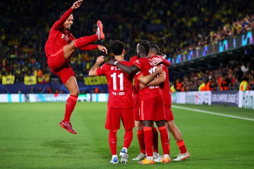 Liverpool players celebrate after scoring a goal.