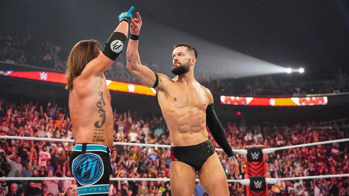 AJ Styles and Finn Balor making the signature &#039;Too Sweet&#039; gesture of the Bullet Club