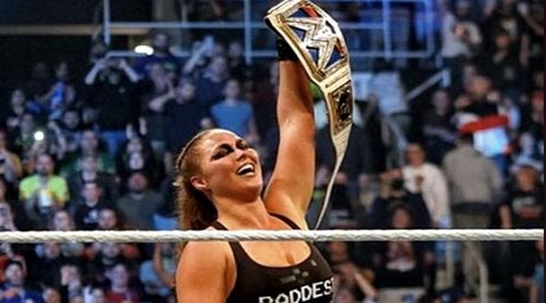 Ronda Rousey captured the WWE Smackdown Women's title by forcing Charlotte to say, "I Quit"