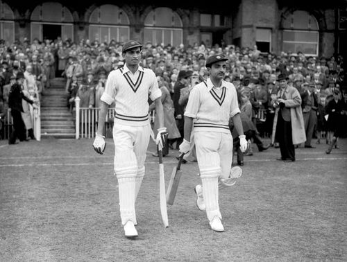 Vijay Merchant (right) walking out to open with Mushtaq Ali. Merchant’s all-time first-class career average of 71.64 per innings is second only to Sir Donald Bradman’s monumental 95.14.