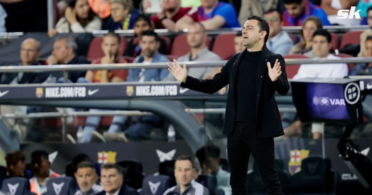 Barcelona boss Xavi Hernandez looks on.