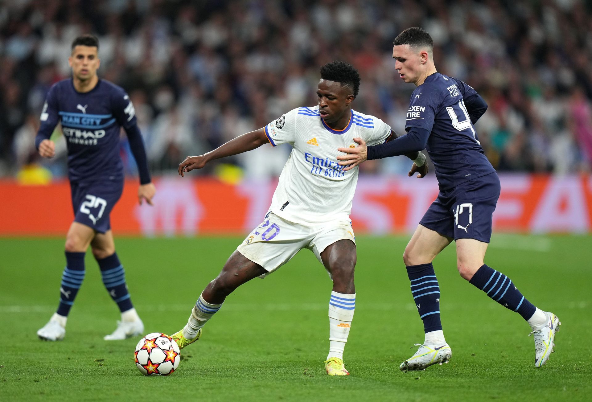 Vinicius Jr tussles it out against Phil Foden