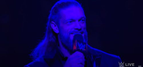 Edge cutting a promo after attacking Styles.