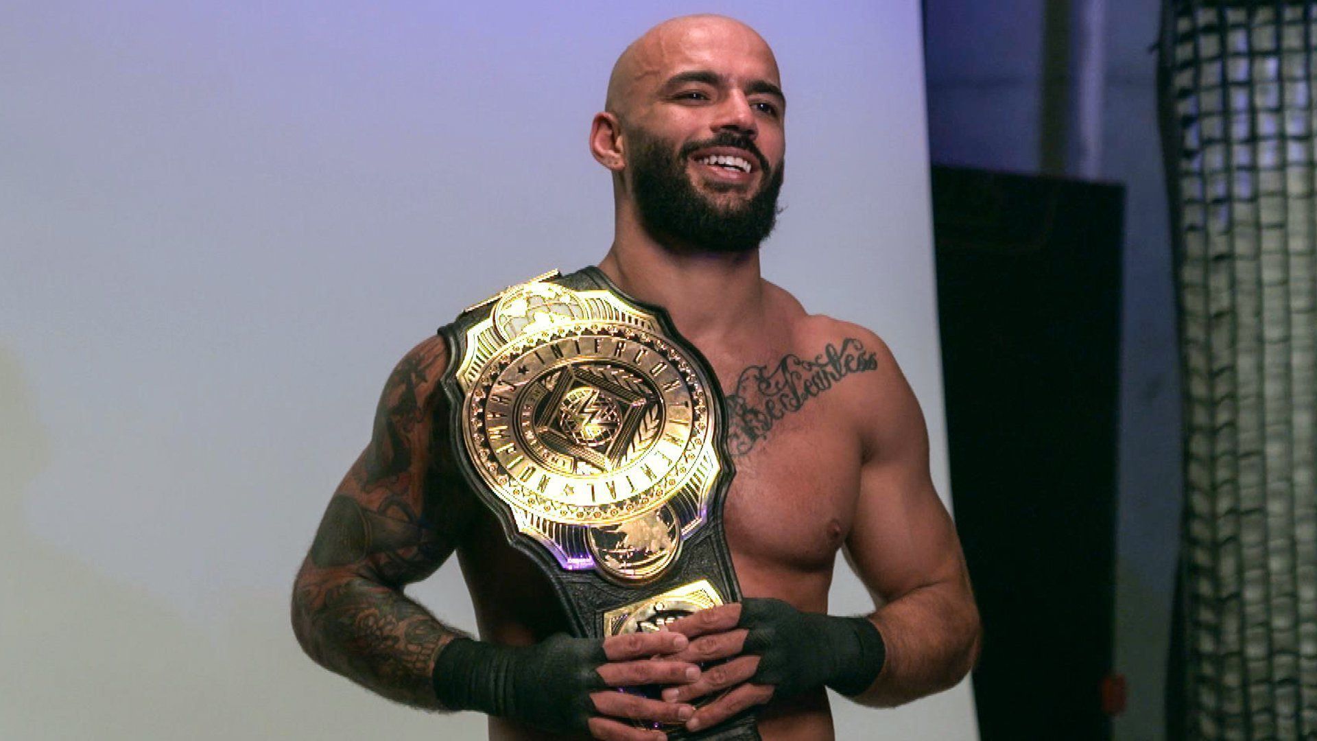 WWE Superstar Ricochet poses with the IC Title/Credit WWE