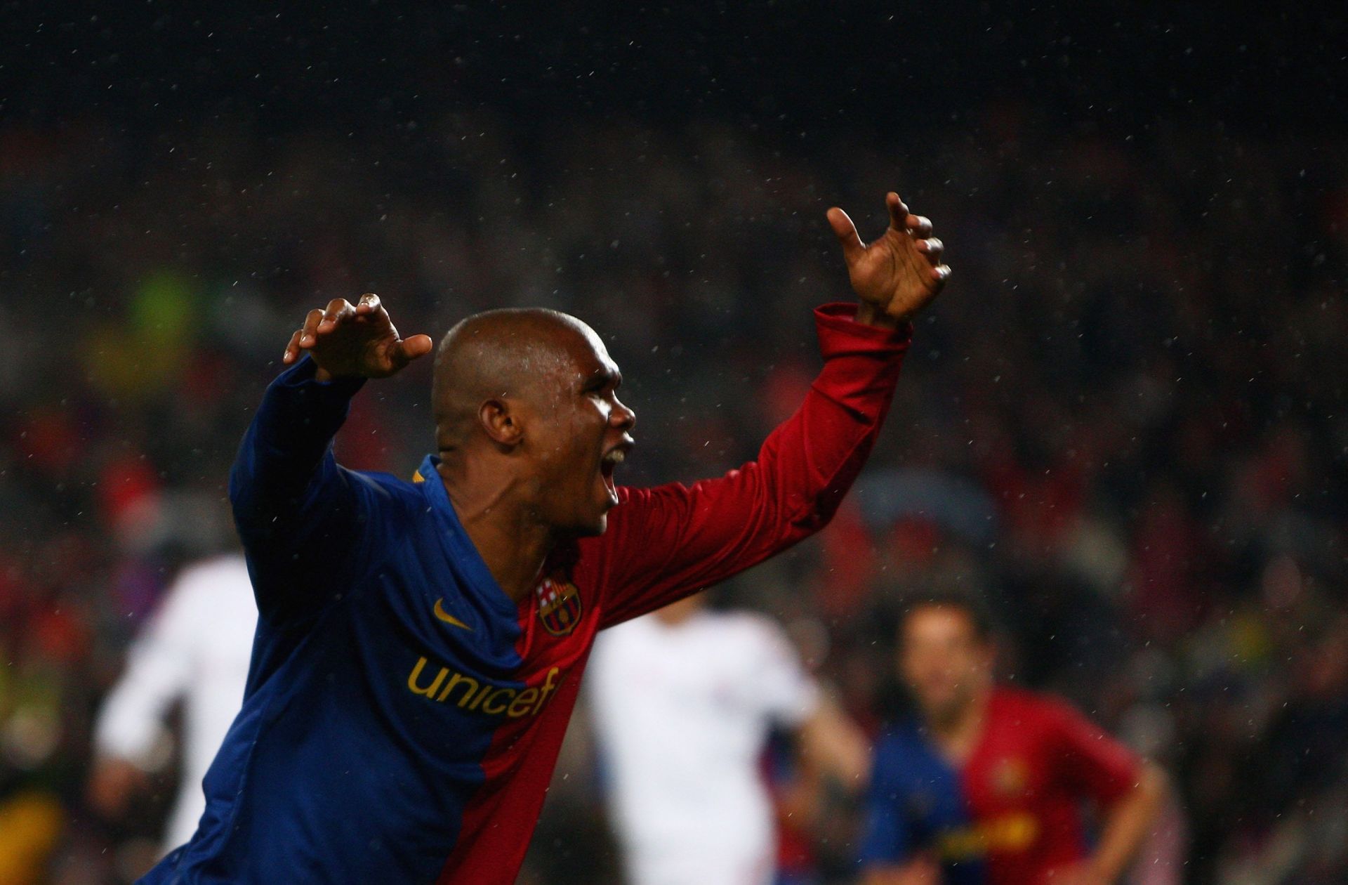 Eto'o celebrates after scoring against Manchester United