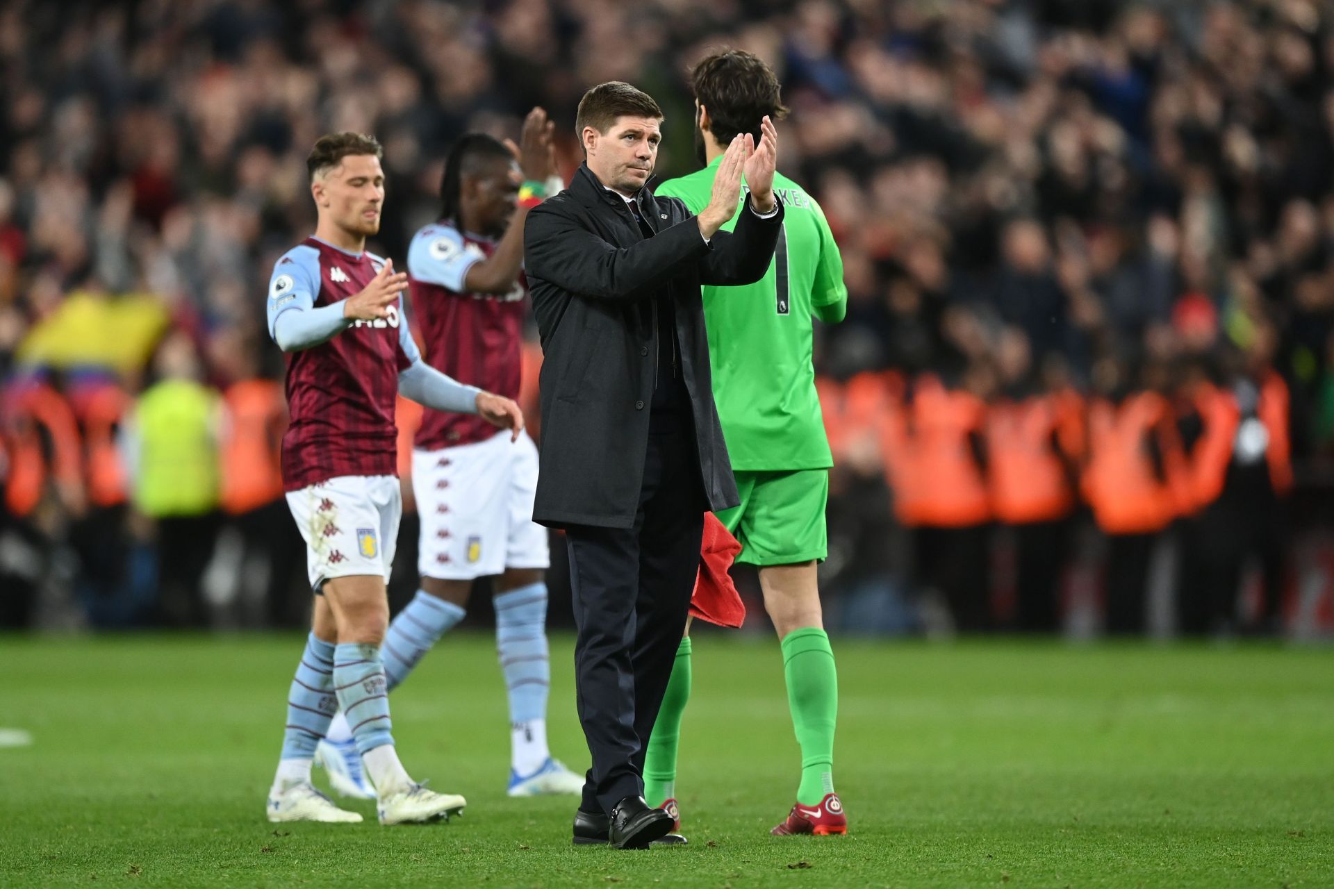 Steven Gerrard (C) and the Aston Villa players applaud the home crowd