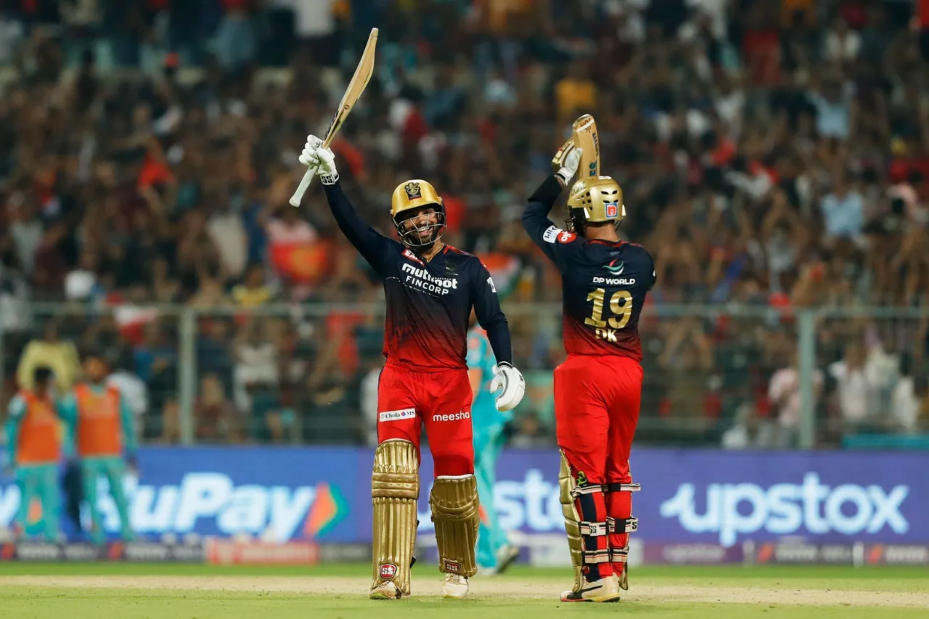 Dinesh Karthik (right) applauds Rajat Patidar’s special knock. Pic: IPLT20.COM