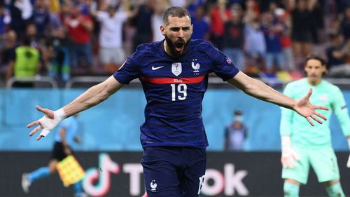 Karim Benzema celebrates scoring the game's opening goal against Denmark.