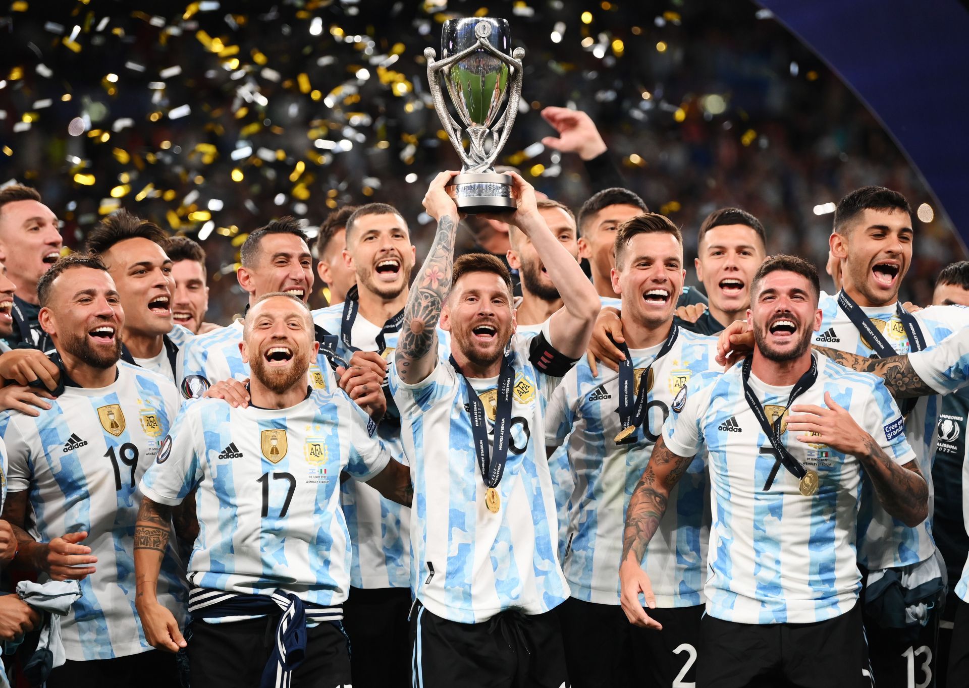 Argentina celebrate winning the Finalissima against Italy by hoisting the trophy.