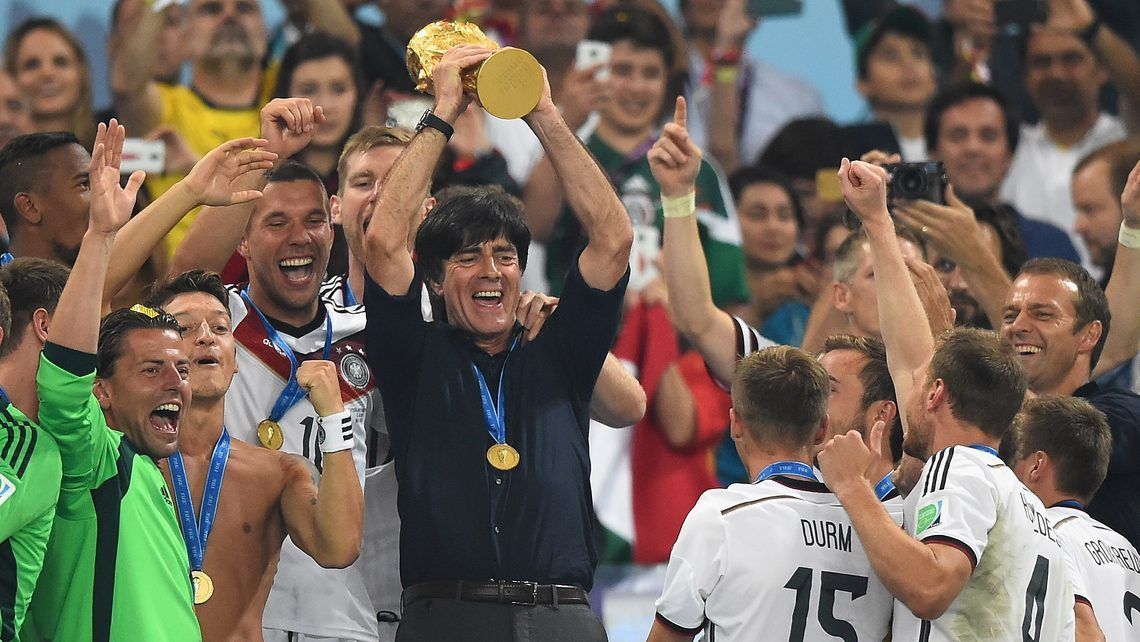 Löw lifting 2014 World Cup with German players.