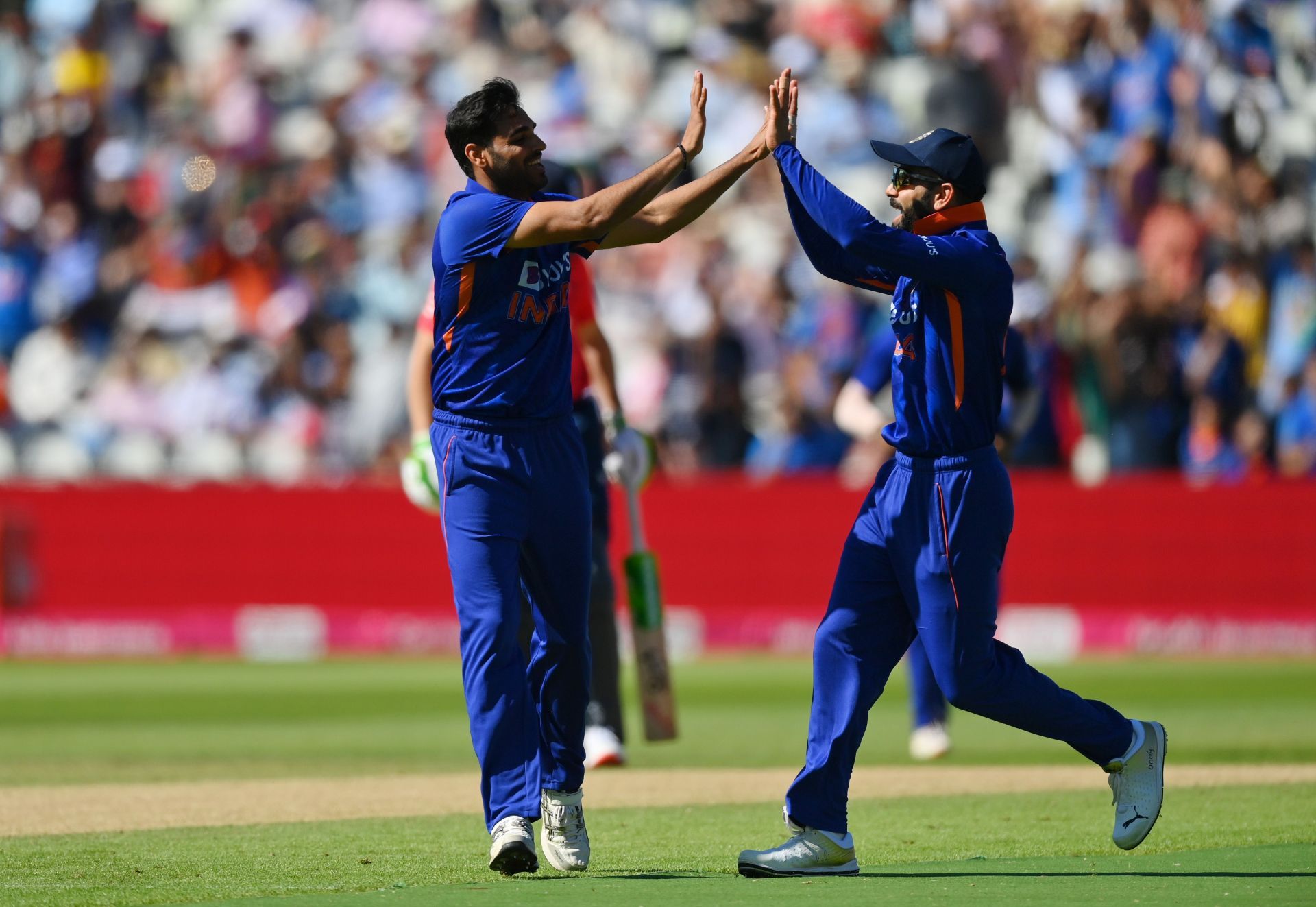 Bhuvneshwar Kumar celebrates with Virat Kohli after taking the wicket of Jason Roy. Pic: Getty Images