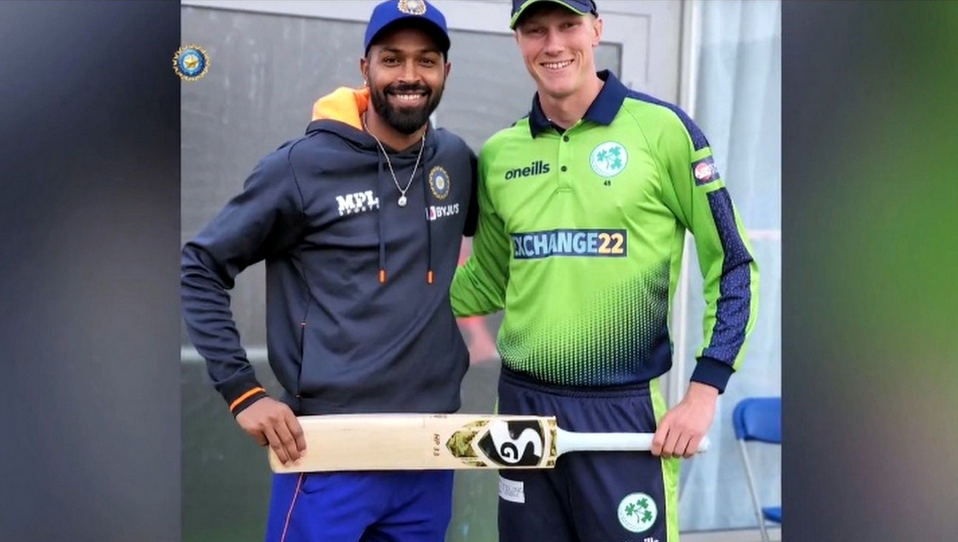 Hardik Pandya (left) gives a bat to Harry Tector (right). Image: Twitter/@BCCI