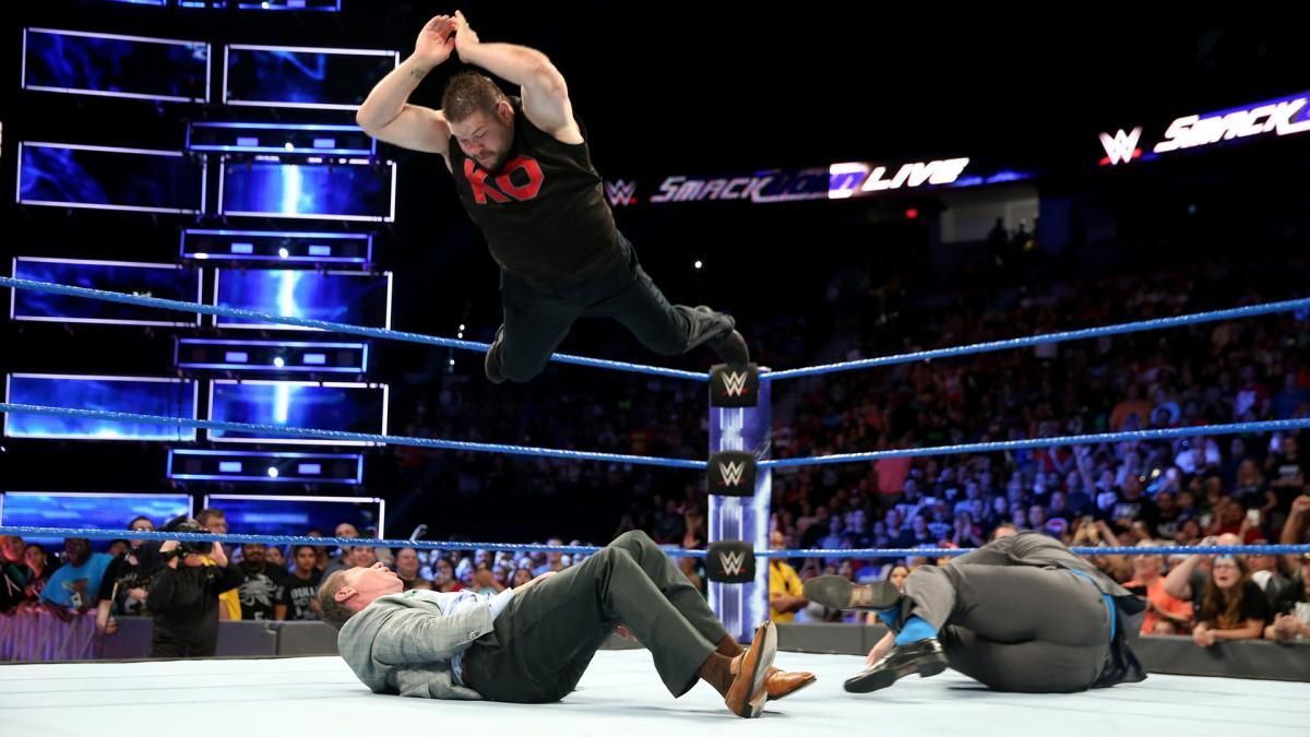 Kevin Owens delivering a frog splash to Vince McMahon