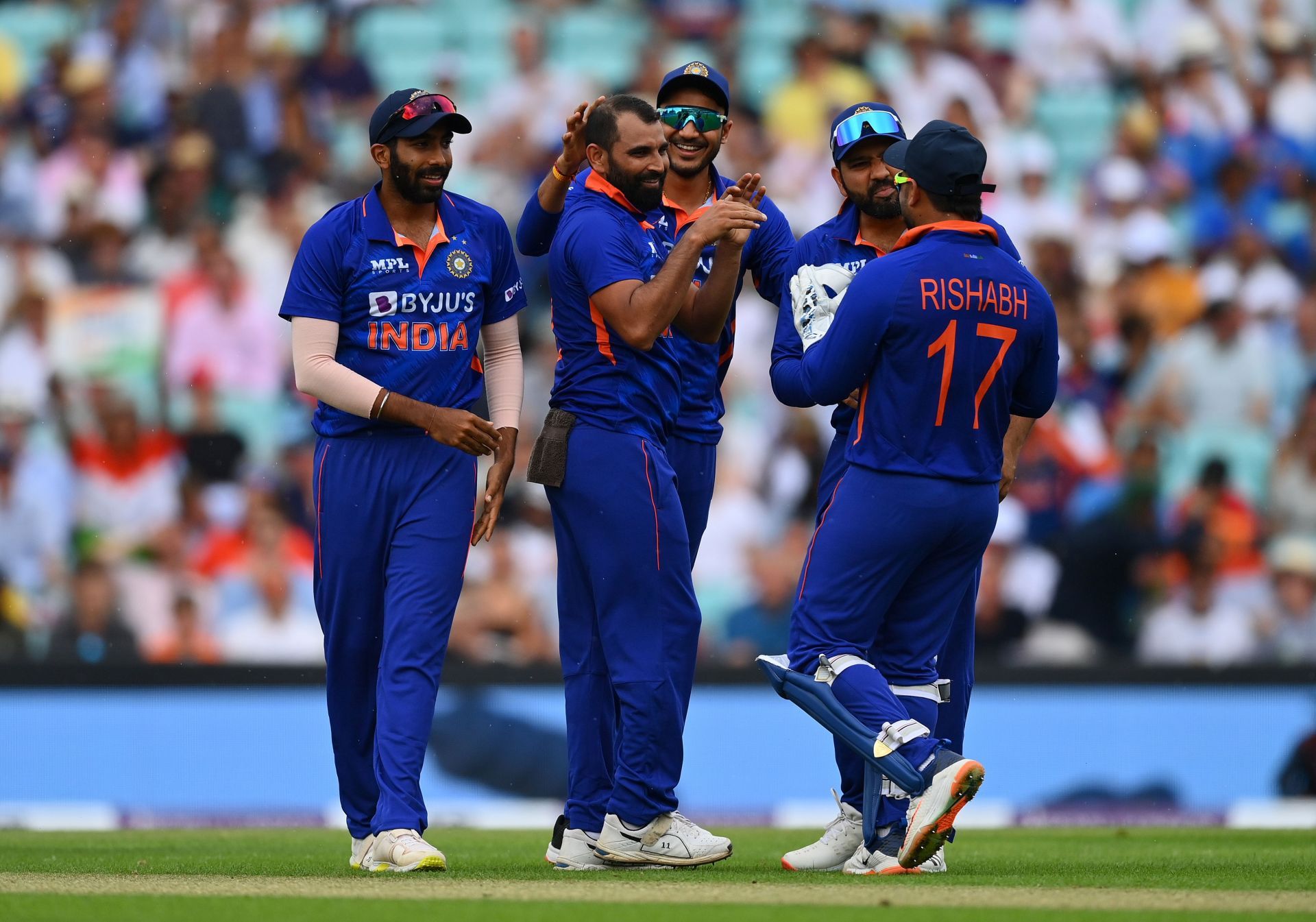 Mohammad Shami celebrates with teammates after taking the wicket of Jos Buttler. Pic: Getty Images