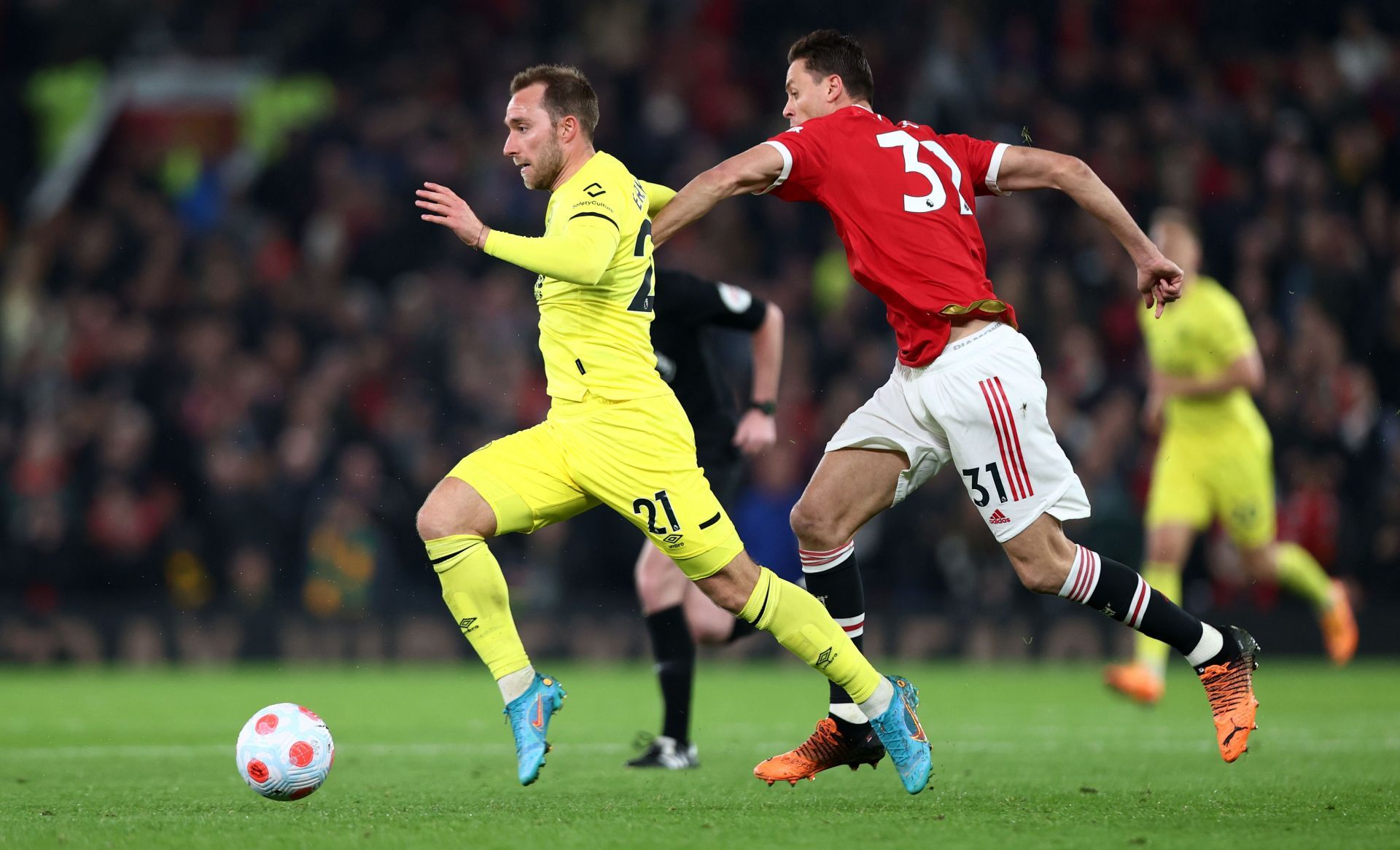 Christian Eriksen brushing aside Nemanjna Matic.