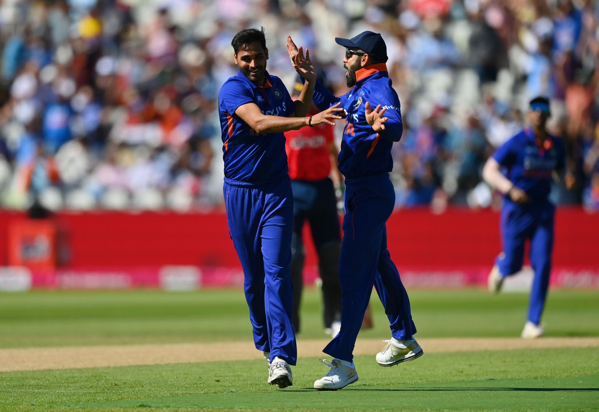 Bhuvneshwar Kumar (left) celebrates with Virat Kohli after taking the wicket of Jason Roy. Pic: Getty Images