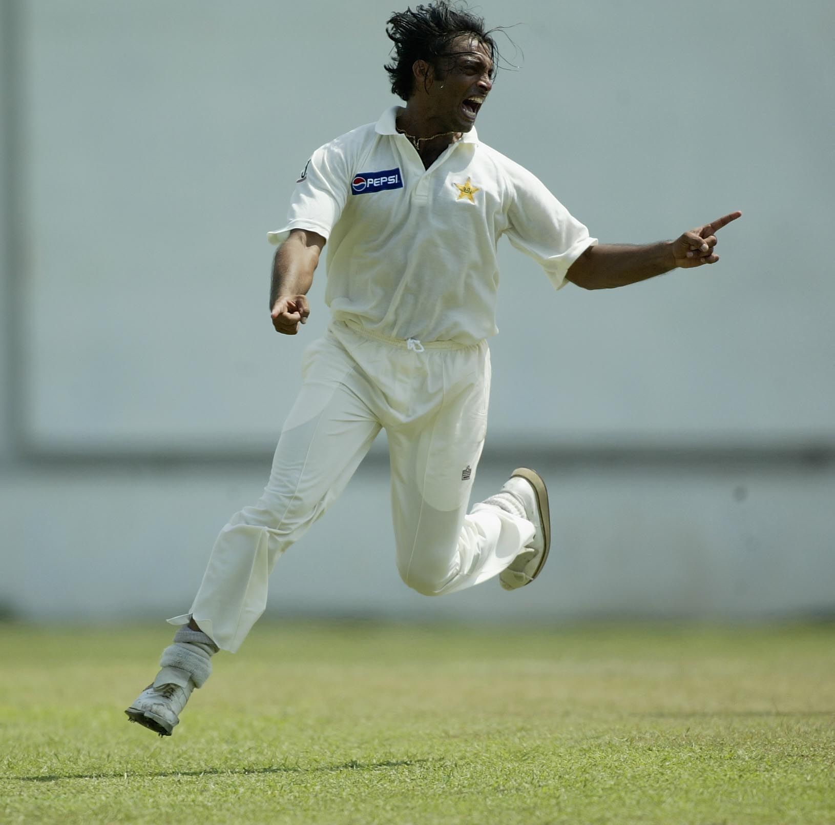 Shoaib Akthar of Pakistan celebrates clean bowling Adam Gilchrist of Australia