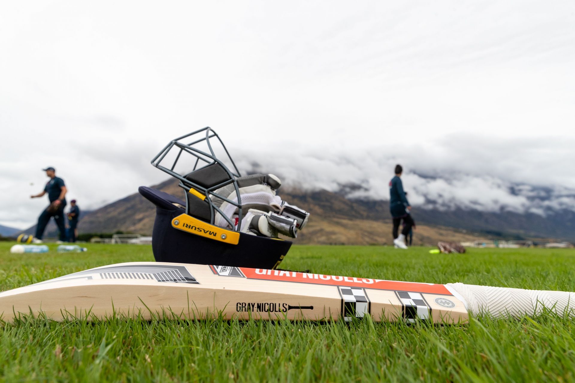 An image displaying a cricket bat, gloves &amp; helmet  