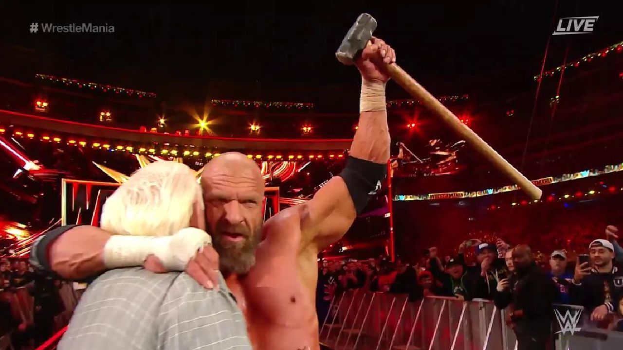 Triple H hugs Ric Flair after a vicious back-and-forth with Batista at WrestleMania 35