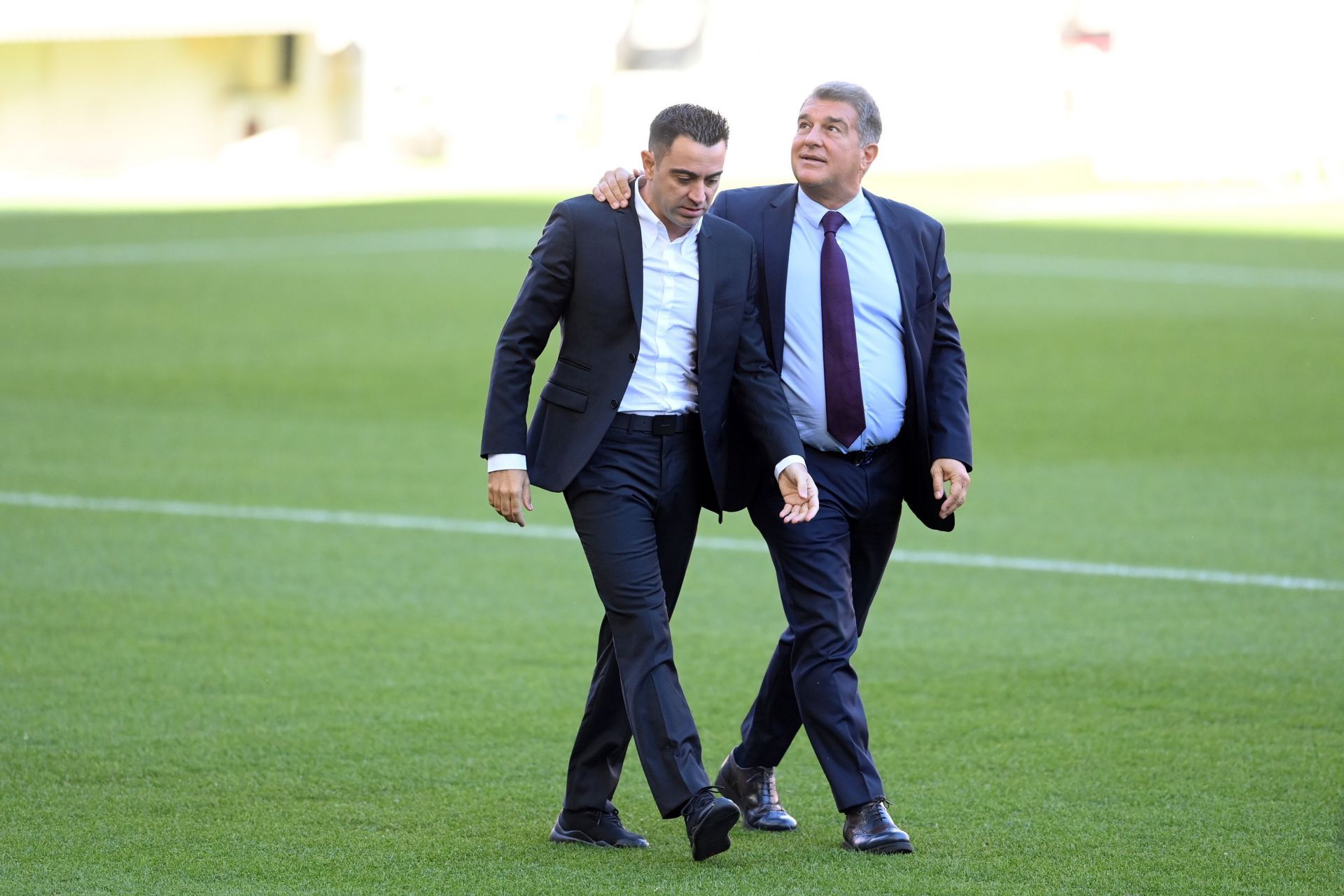 Xavi Hernandez (left) and Joan Laporta (right)