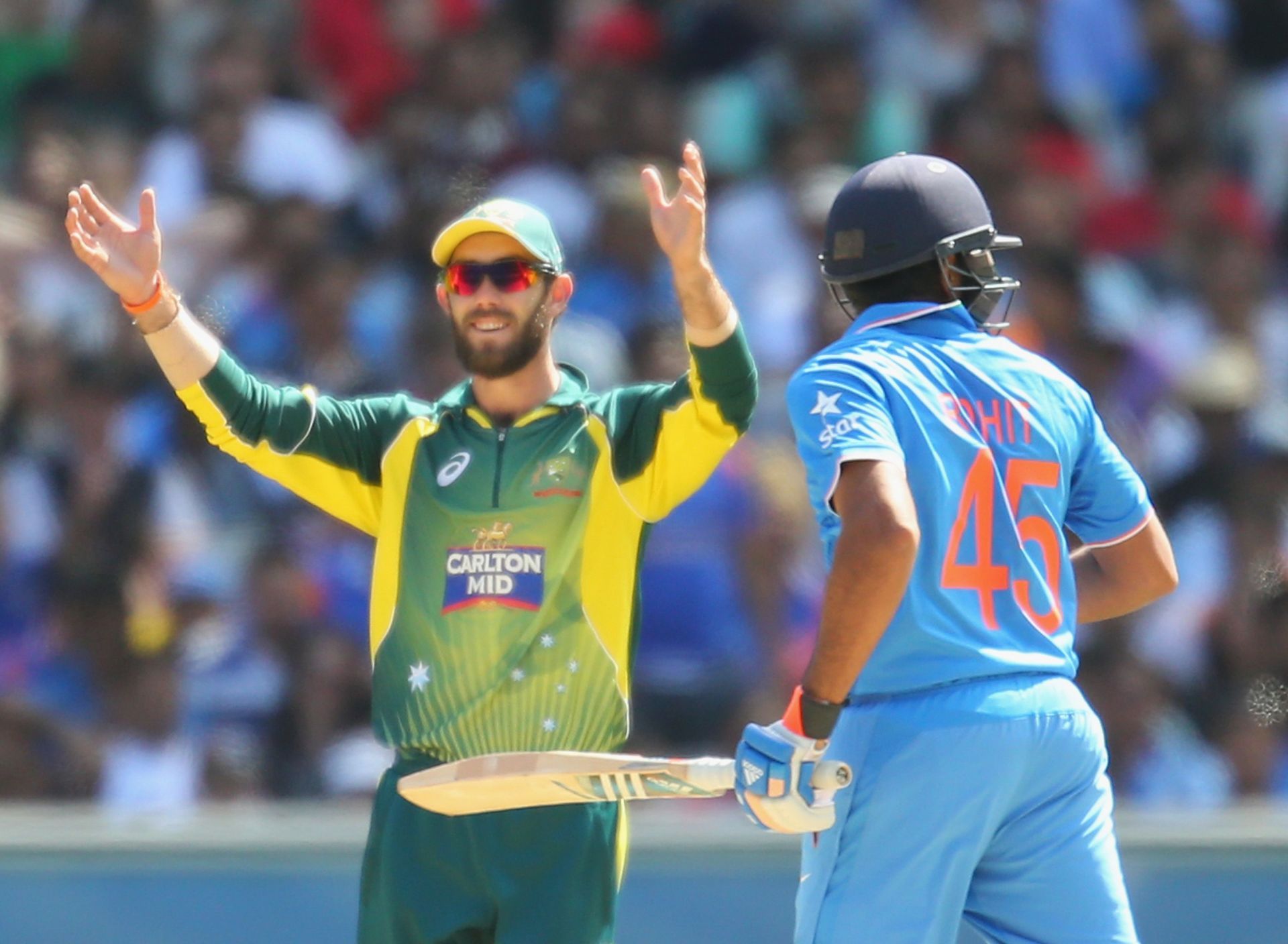 Glenn Maxwell gestures as Rohit Sharma takes a run during an ODI at the MCG in January 2015. Pic: Getty Images