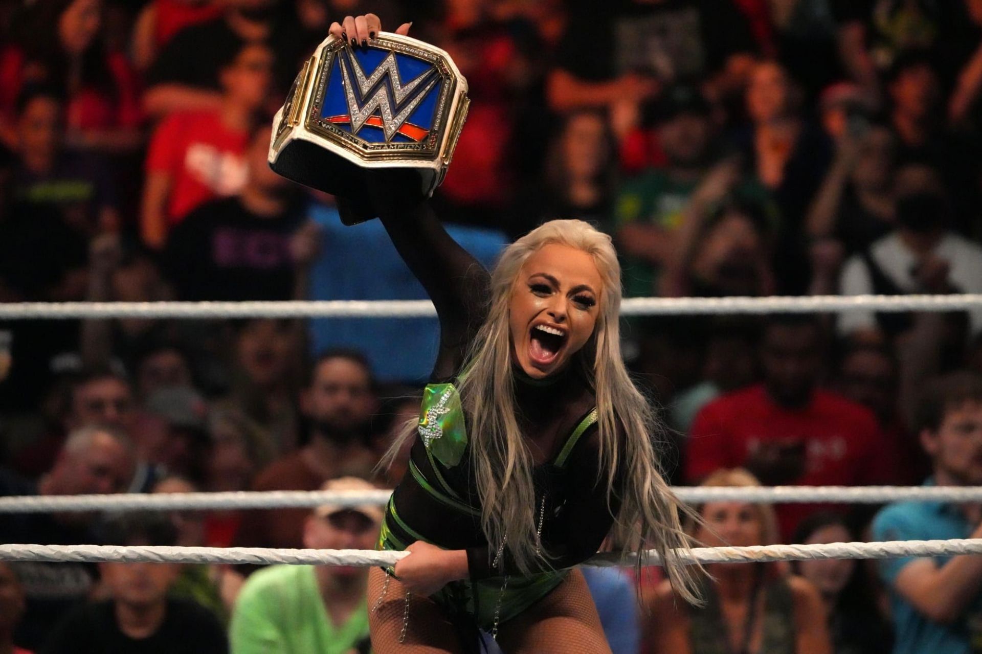 Liv is holding up the SmackDown Women's Championship