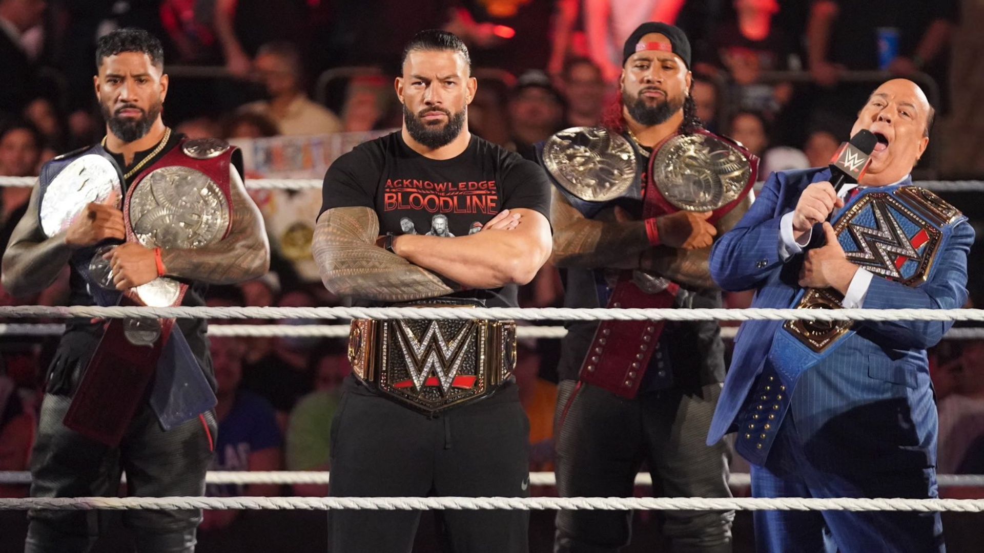 Left to right: Jey Uso, Roman Reigns, Jimmy Uso, and Paul Heyman