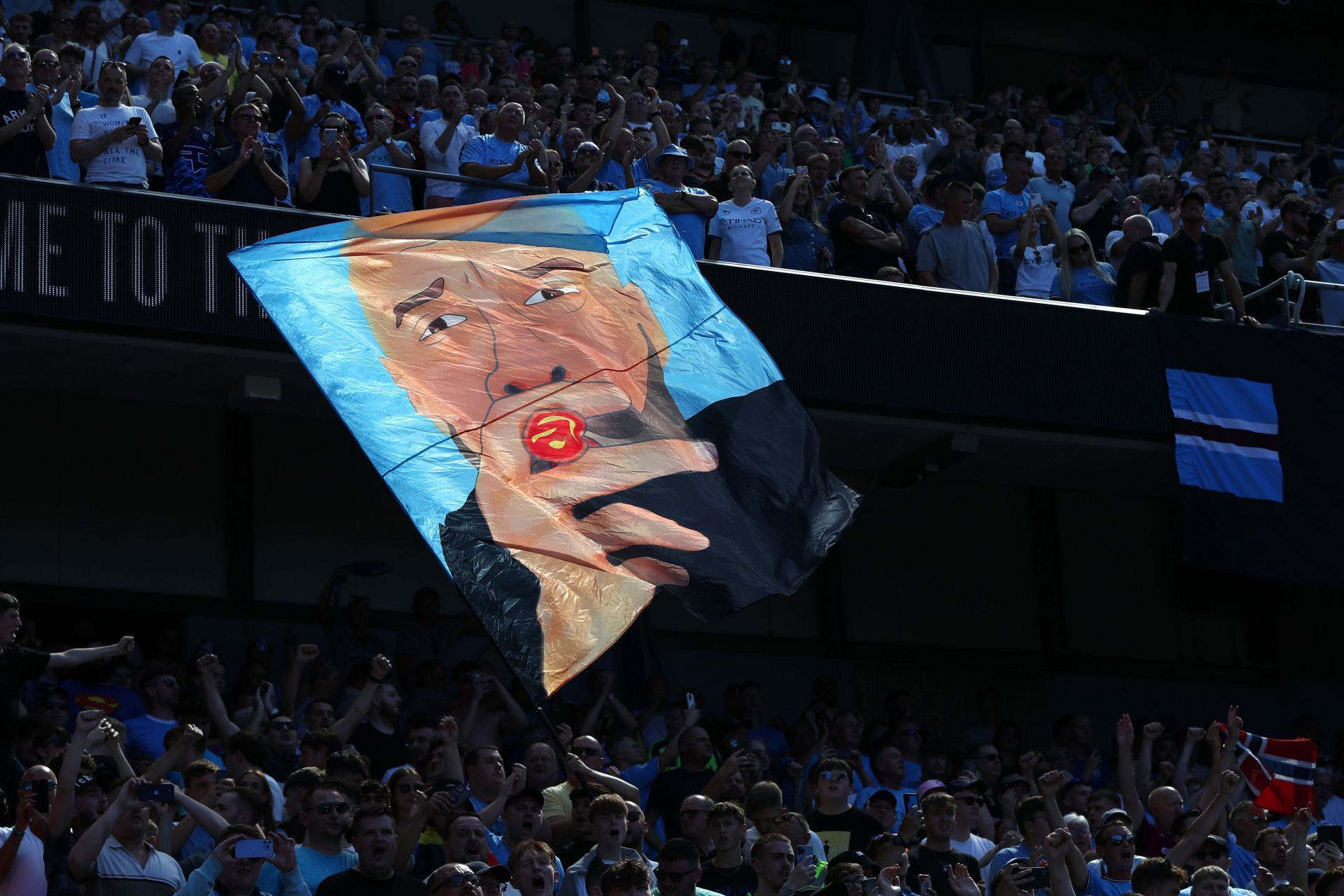 Manchester City fans with a banner celebrating Pep Guardiola.