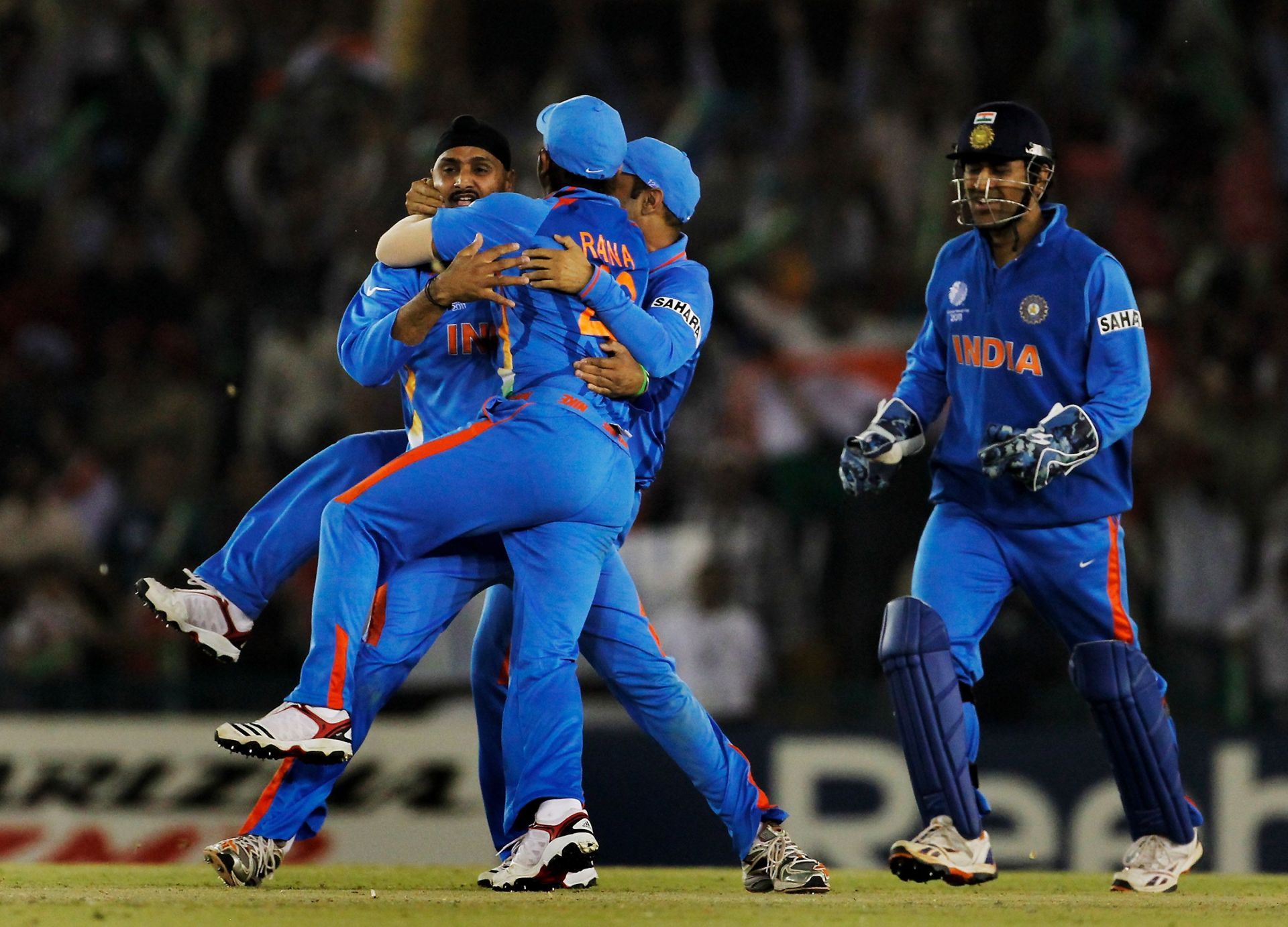 Harbhajan Singh celebrates with teammates as MS Dhoni looks on. Pic: Getty Images