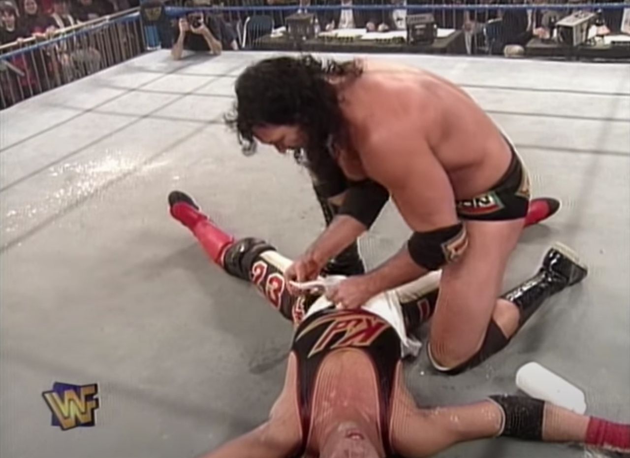 Razor Ramon placing a diaper on an unconscious 1-2-3 Kid