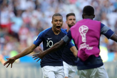 Barcelona's Ousmane Dembele with PSG's Kylian Mbappe