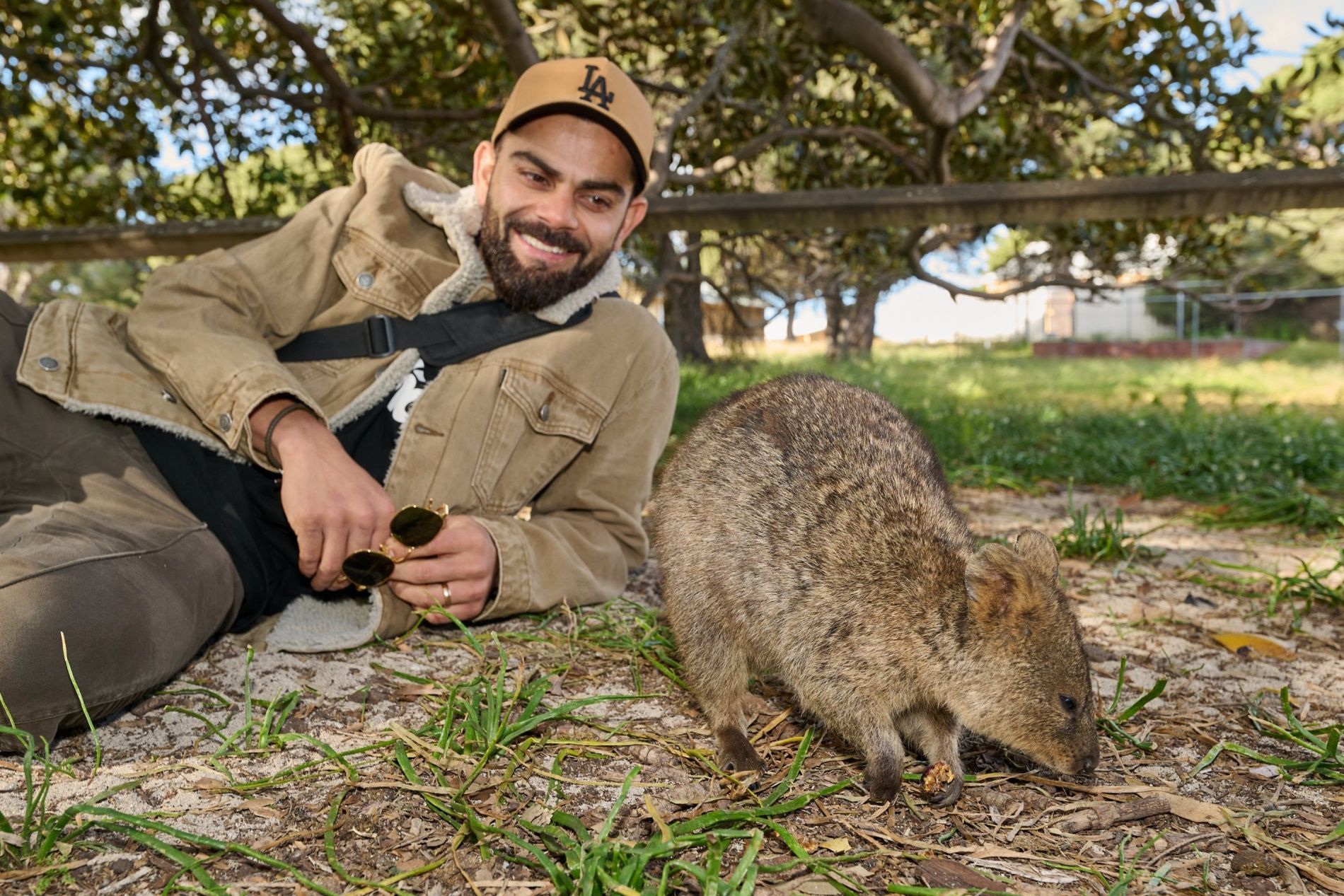 Virat Kohli poses with a quokka.