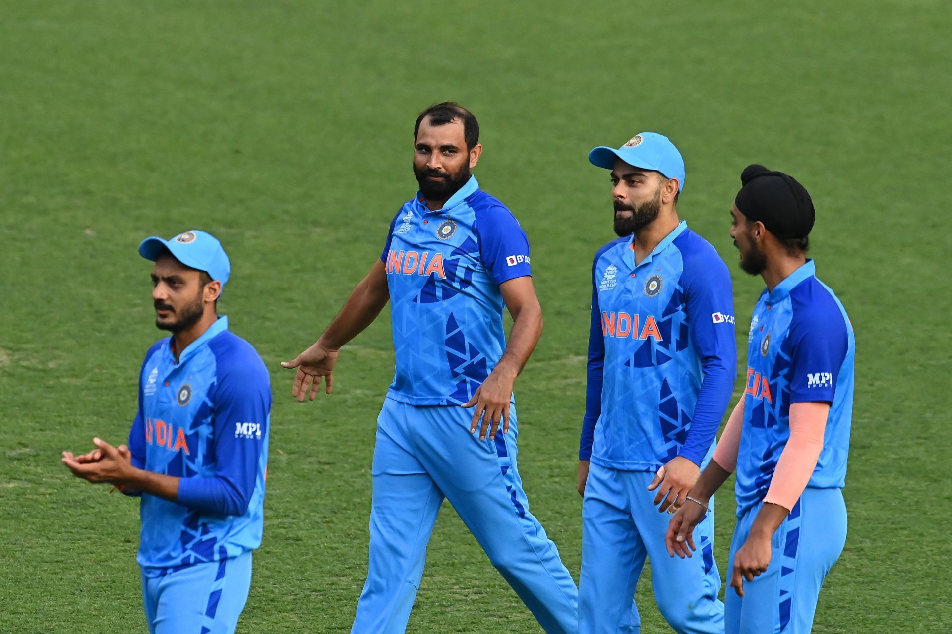 Mohammed Shami walks off with his teammates after India