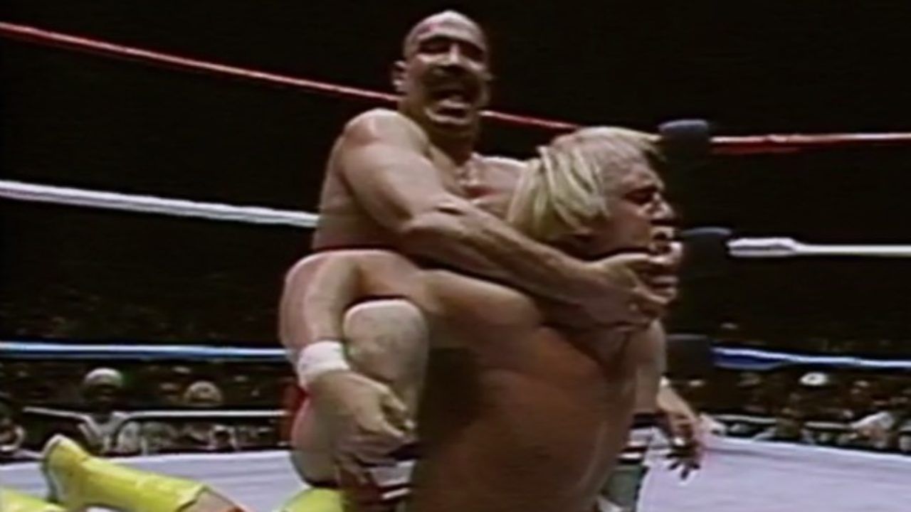 The Iron Sheik holds Hulk Hogan in his infamous Camel Clutch during the WWE Championship bout.