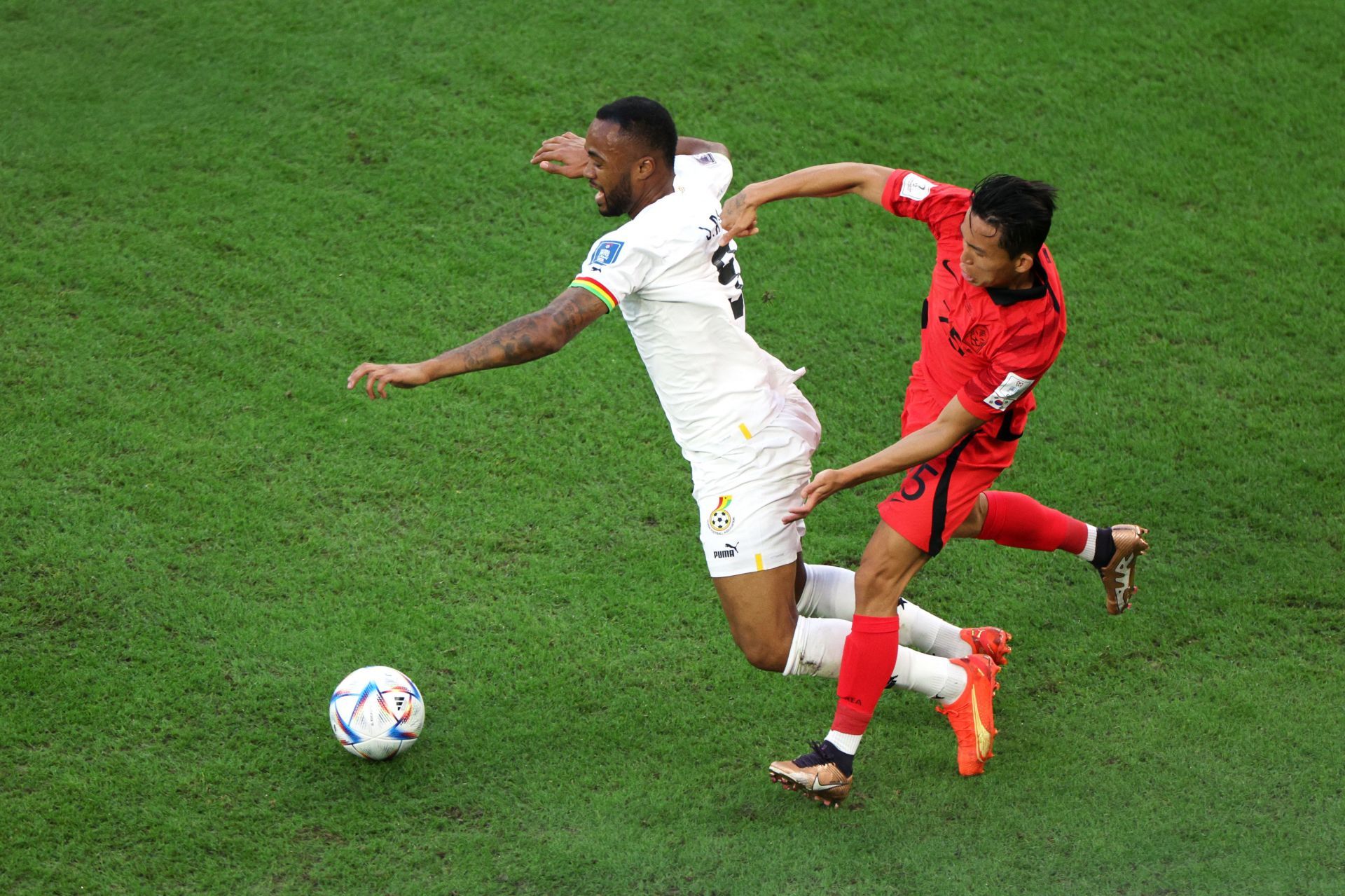 Jordan Ayew is tackled by Wooyeong Jeong.