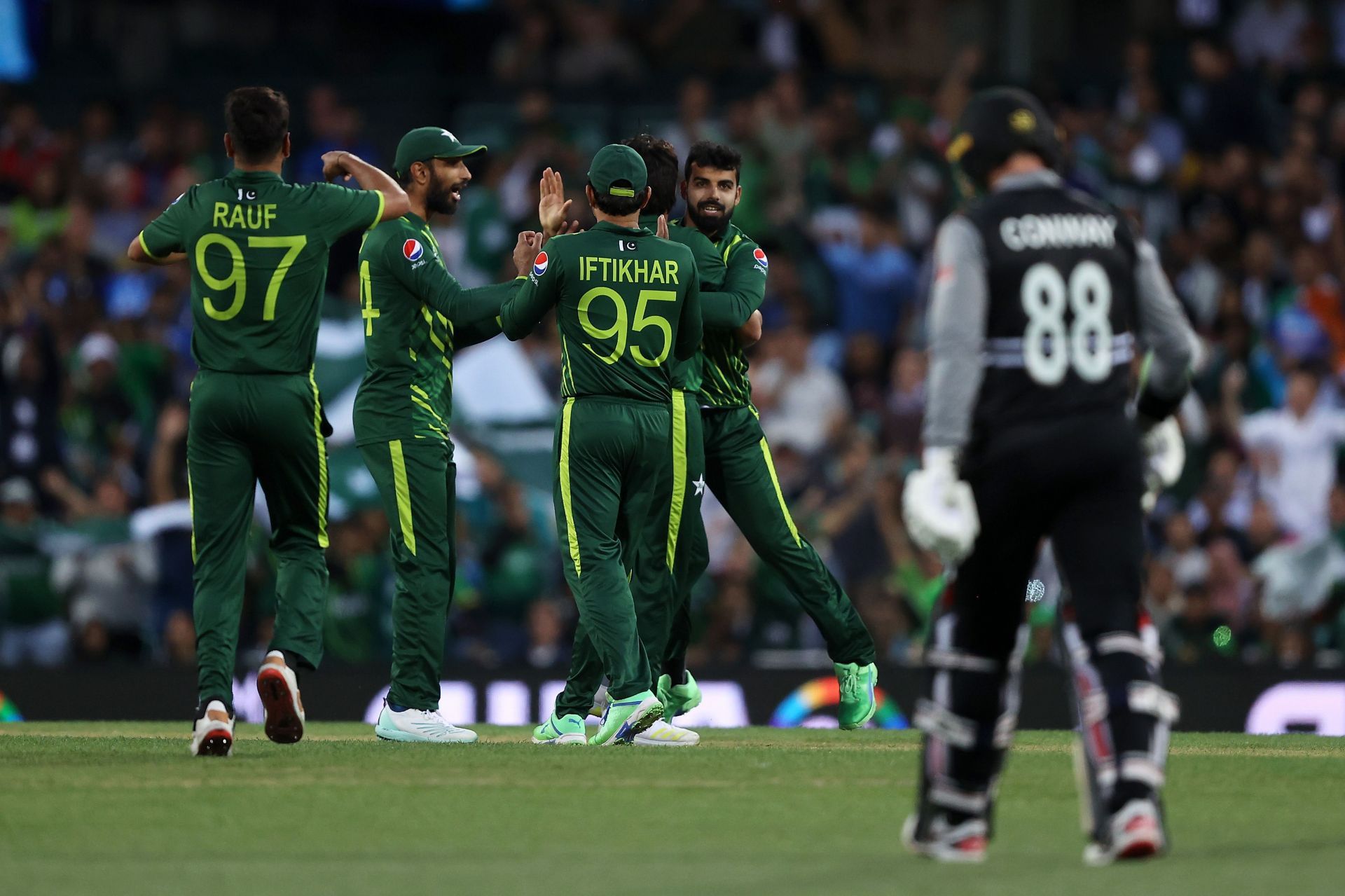 Pakistan players celebrate as Shadab Khan&#039;s direct hit dismisses Devon Conway.