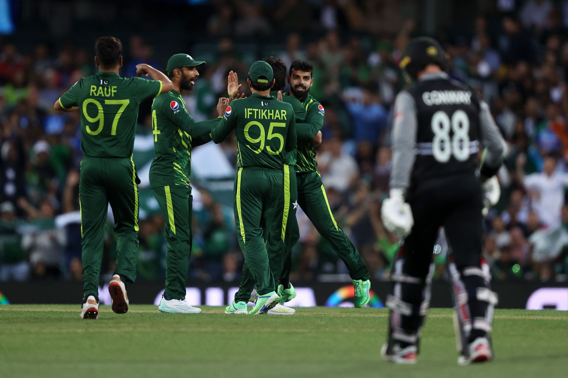 Pakistan players celebrate as Shadab Khan's direct hit dismisses Devon Conway.