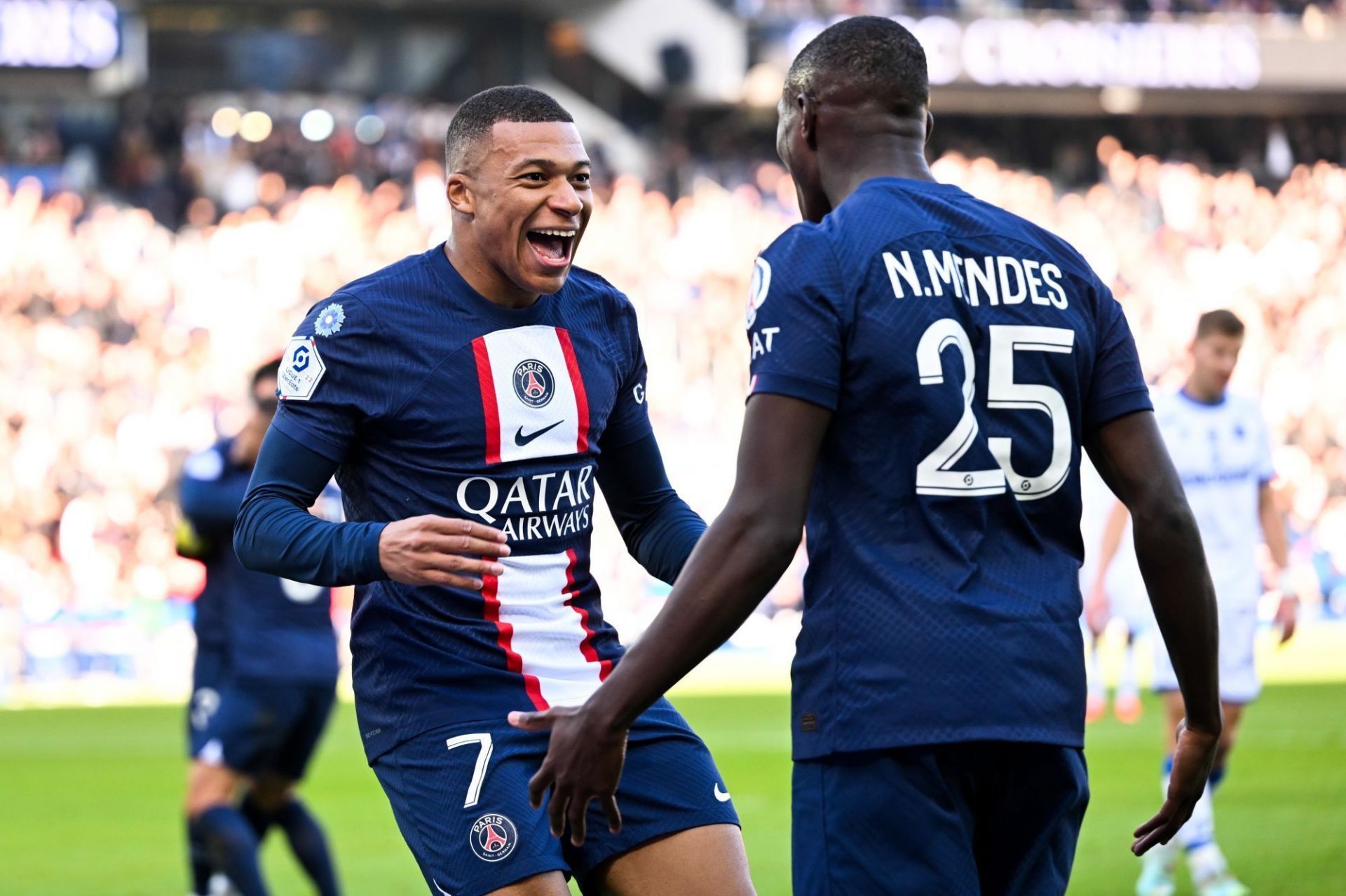 Kylian Mbappe and Nuno Mendes celebrate scoring for Paris Saint-Germain.