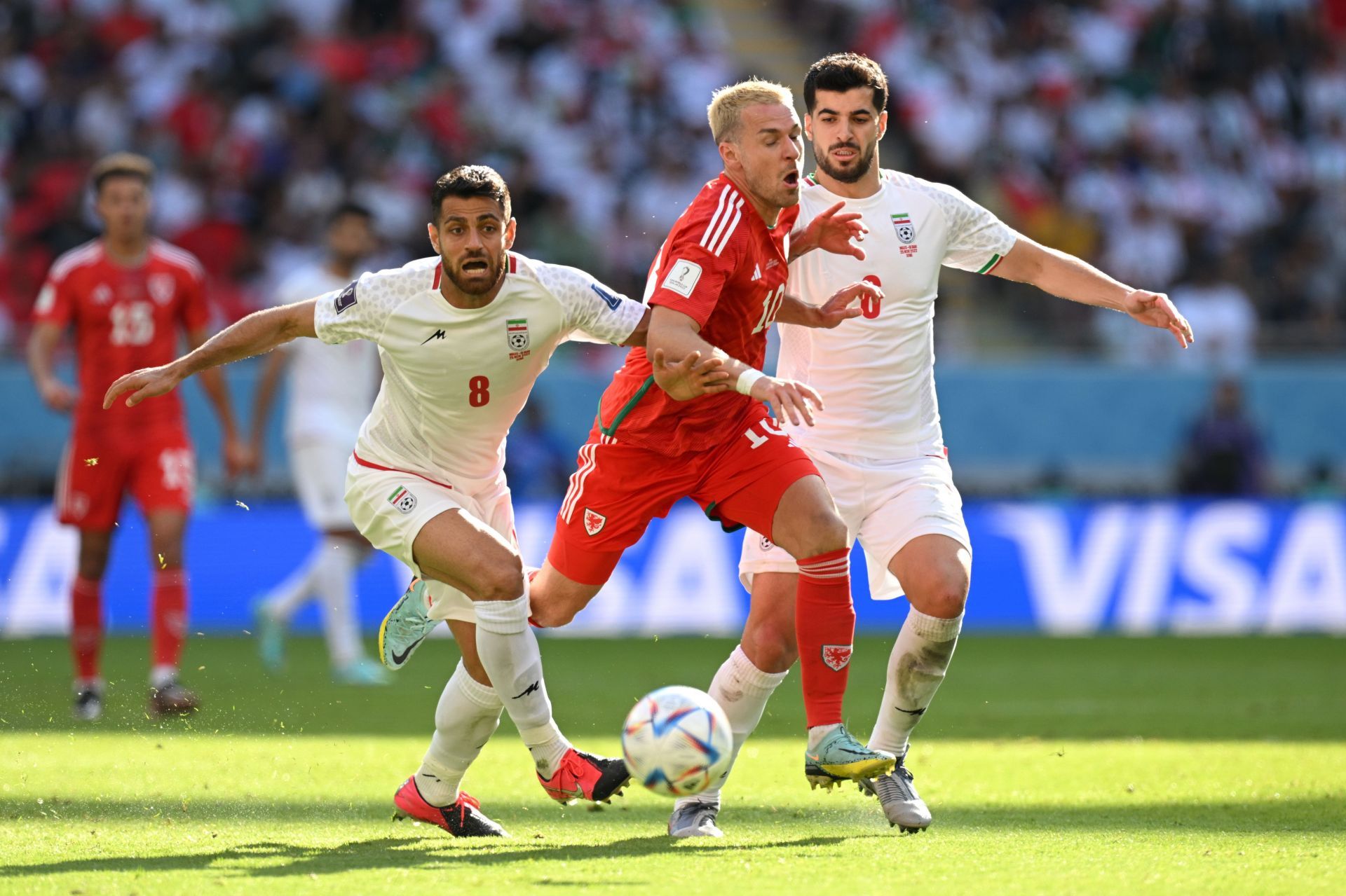 Aaron Ramsey battles for possession with Morteza Pouraliganji at Ahmad Bin Ali Stadium in Doha, Qatar.