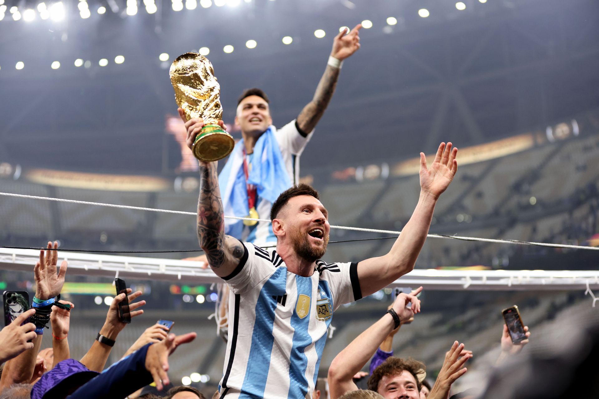 Lionel Messi celebrating after winning the World Cup trophy
