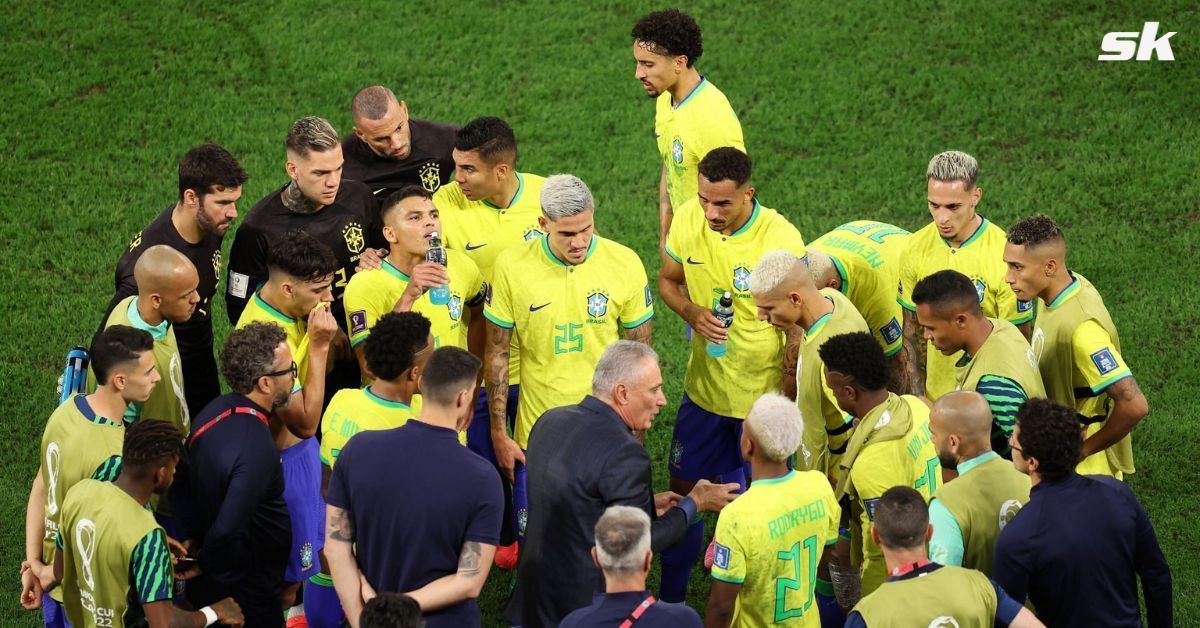 Brazil players listen to Tite (bottom middle) during a 2022 FIFA World Cup game.