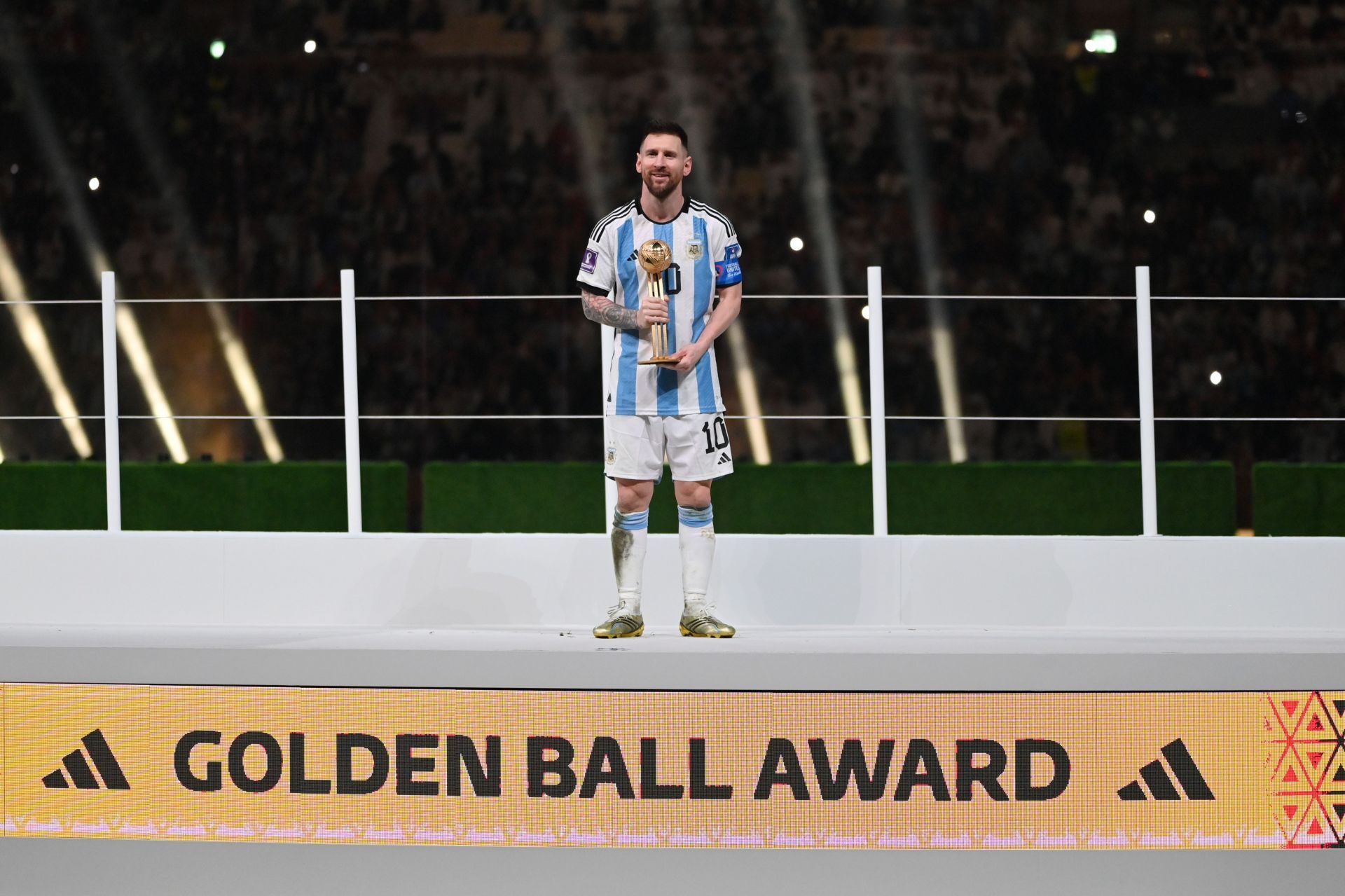 Lionel Messi poses with the Golden Ball award.