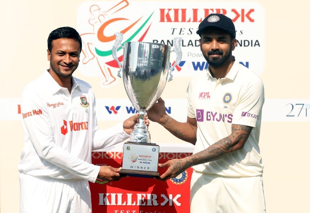 Shakib Al Hasan (L) and KL Rahul (R) posing with the Test trophy [Pic Credit: BCCI]