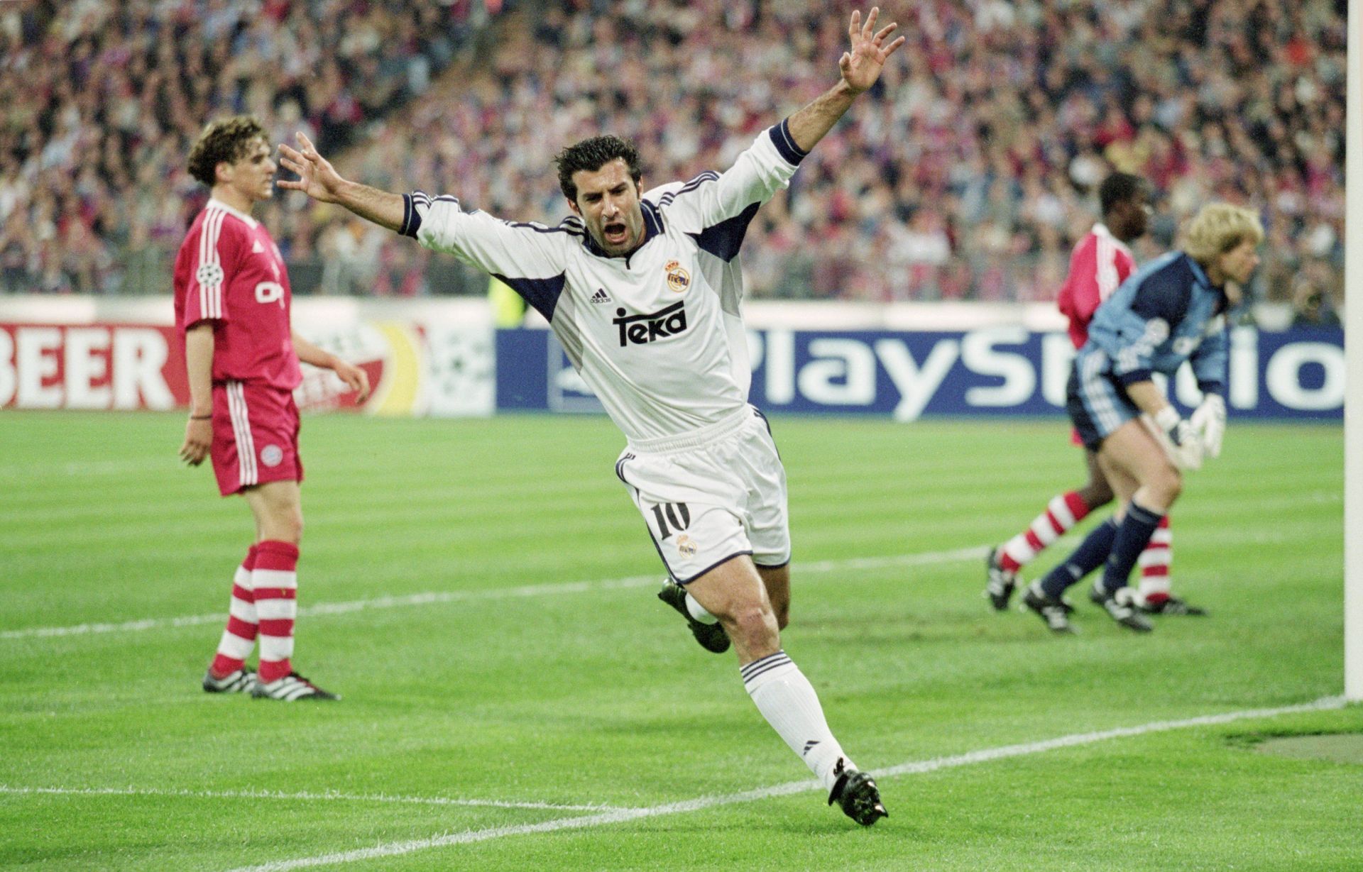 Luis Figo celebrates after scoring a goal for Real Madrid
