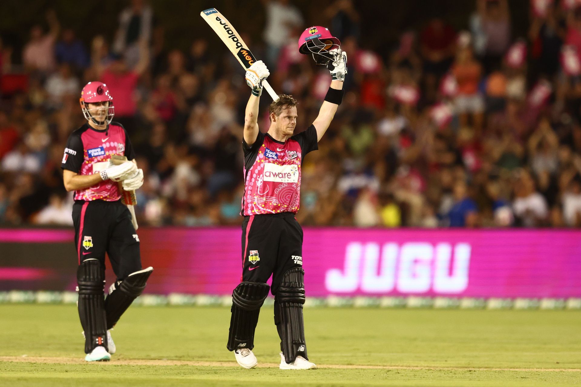 Steve Smith raises his bat and helmet after a hundred against the Adelaide Strikers. (Credits: Getty)