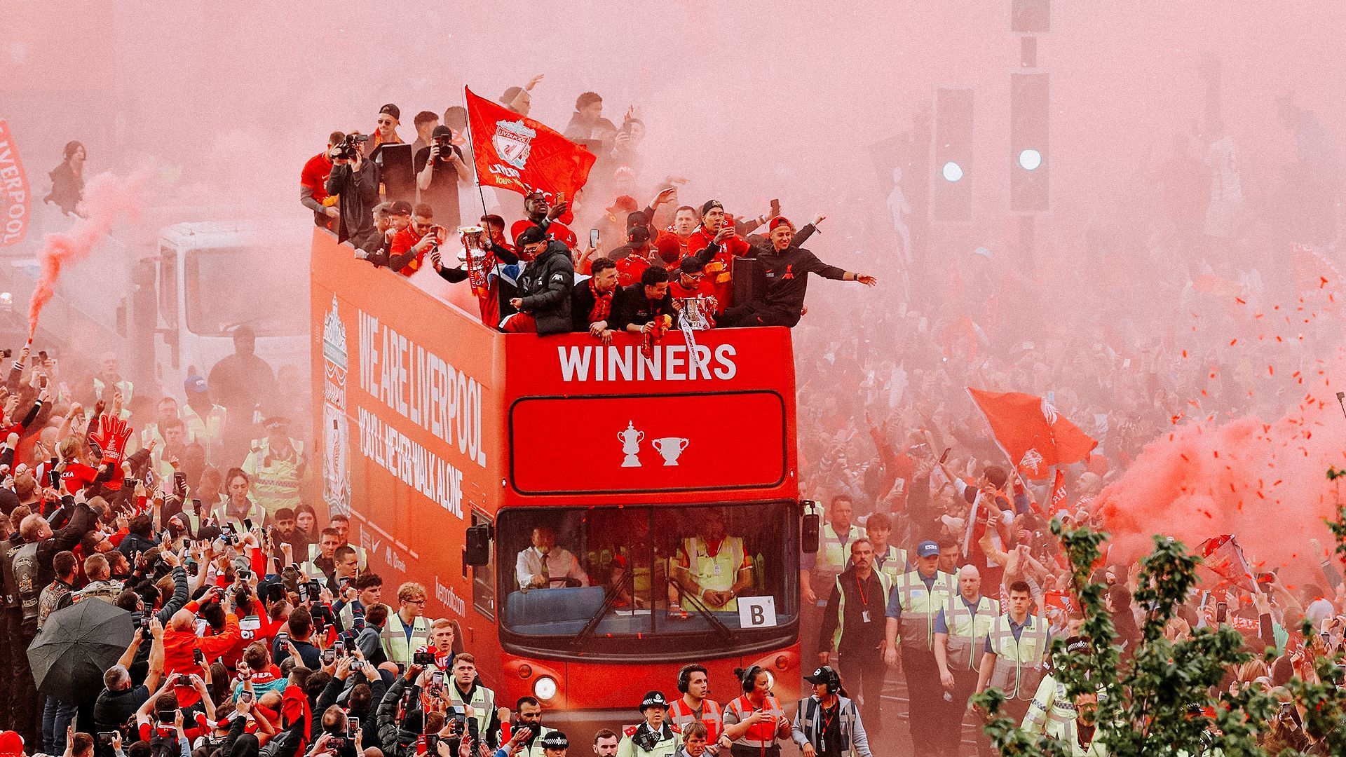 Bittersweet: Liverpool share last season's trophy haul with their fans- the day after losing the Champions League final.