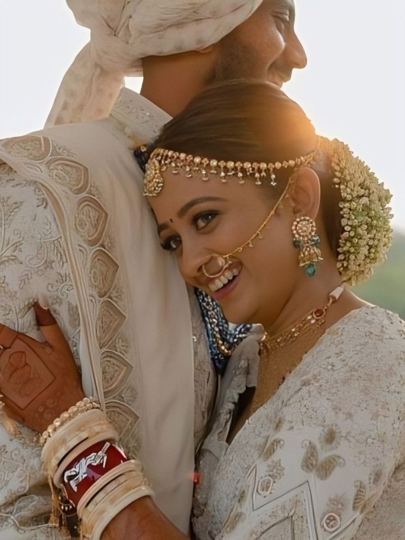 The newly-married couple exchange a hug.